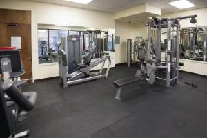 a gym with several tread machines in a room at Island Colony 3519 - 30 night minimum in Honolulu
