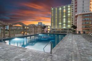 a large swimming pool in front of a building at Island Colony 3519 - 30 night minimum in Honolulu