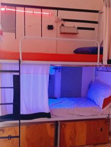a bunk bed in a room with two beds at Ostello Exclusive Dependance - IT CLOSES AT NINE PM in Palermo