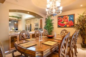 a kitchen and dining room with a wooden table and chairs at Club Marena Condo 501 in Rosarito
