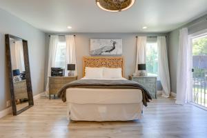 a bedroom with a large bed and two windows at Family Home with Pool about 7 Mi to Downtown Sacramento! in Sacramento +28 photos
