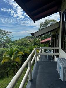 a balcony of a house with a view of the ocean at Hotel La Colina in Manuel Antonio