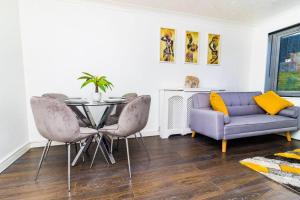 a living room with a table and a couch at Shazeal Apartments in Birmingham