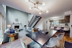 a dining room and living room with a table and chairs at Brentwood Burrow in East Stroudsburg