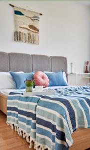 a bed with a blue and white blanket on it at Wonderful Panoramic View Apartment in Mukacheve