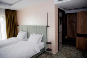 a bedroom with two beds with white pillows at RIVER PLACE in Piteşti