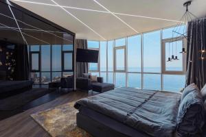 a bedroom with a bed and a view of the ocean at Odesa Pearl Arcadia in Odesa