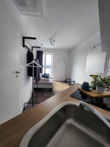 a kitchen with a sink in the middle of a room at Cozy Apartment with WIFI, Near University&Hospital in Augsburg