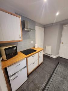 a kitchen with a counter and a microwave at 2 Kilkerran Road in Campbeltown
