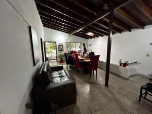 a living room with a table and a leather couch at Hostel Urban City Medellin in Medellín
