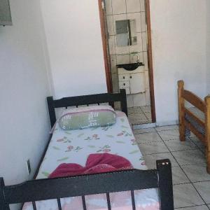 a small bedroom with a bed in a room at Beijaflor Pousada in Corumbá