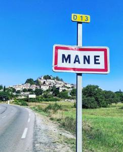 a sign for a man on the side of a road at La Guitoune in Mane