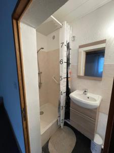 a bathroom with a sink and a tub and a toilet at La Guitoune in Mane