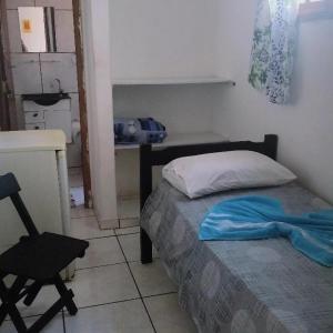 1 dormitorio pequeño con 1 cama y 1 silla en Beijaflor Pousada, en Corumbá