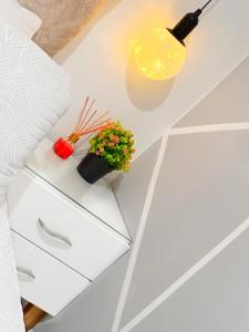 a table with a lamp and a plant on it at Habitación VIP in Ibagué