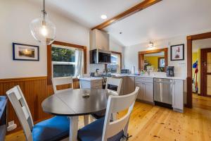 a kitchen with a table and a table and chairs at Taylor Made Cottage in Bodega Bay