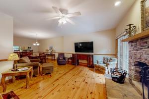 a living room with a fireplace and a tv at Sweet Home Carolina in Cashiers