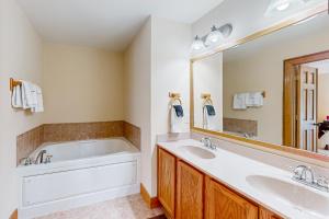a bathroom with two sinks and a tub and a large mirror at Sweet Home Carolina in Cashiers +17 photos