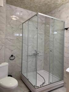 a shower with a glass enclosure in a bathroom at bismillah hotel and restaurent in Gudauri