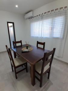 a wooden table and chairs in a room at TresA -1- in Tres Arroyos