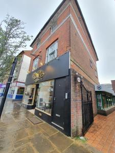 a store front of a brick building on a street at Stylish Ashford Gem - Sleeps 6 in Kent