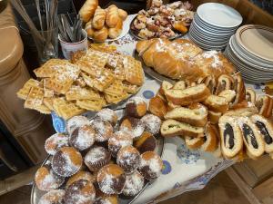 a table filled with different types of pastries and bread at Alva Pension 1 in Mikulov