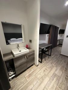 a bathroom with a sink and a desk with a table at Quinta del sol in Chihuahua