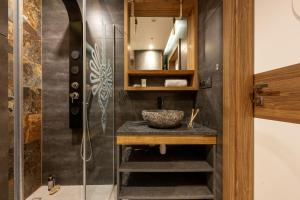 a bathroom with a sink and a shower at Apartamenty Pod Dachem w Centrum APARTZAKOP in Zakopane