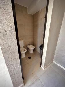 a bathroom with a toilet and a sink at Departamento Moderno ,Torre Blue, Barrio Sur Tucumán in San Miguel de Tucumán