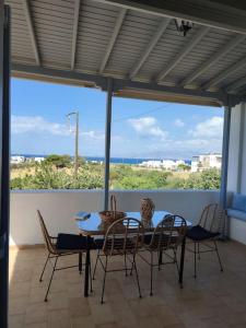 a table and chairs with a view of the ocean at Summer family house 300m from the beach in Kastraki +45 photos