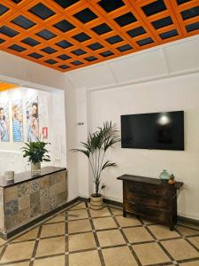 a living room with a flat screen tv on a wall at Arc House Granada in Granada