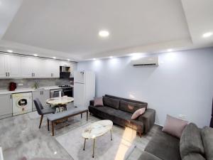 a living room with a couch and a table at Manolyam suit 5 .1+1 in Kaş +1 photo
