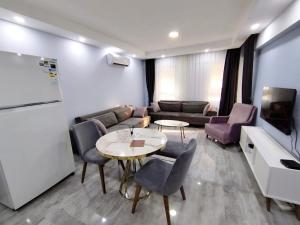 a living room with a couch and a table and chairs at Manolyam suit 5 .1+1 in Kaş