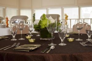 a table with wine glasses and silverware on it at The Bristol Hotel San Diego in San Diego