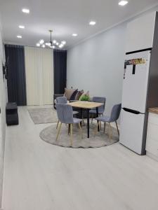 a kitchen and dining room with a table and chairs at Comfortable 2-roomed apartment Ozod Apartments SU2 in Samarkand