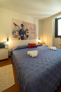 a bedroom with a large blue bed with two pillows at Odi et Amo - Luxury Love in Brescia