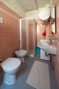 a bathroom with a toilet and a sink and a shower at Odi et Amo - Luxury Love in Brescia