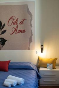 a bedroom with a bed and a sign on the wall at Odi et Amo - Luxury Love in Brescia