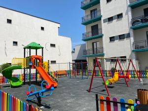 a playground in front of a building at Eric Apartment in Mamaia Nord