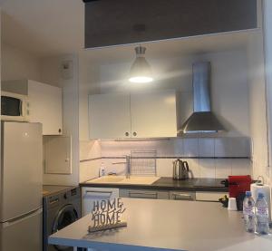 a kitchen with a counter with a home improvement sign on it at "Olympic Sweet Home" Paris Stade de France in Épinay-sur-Seine