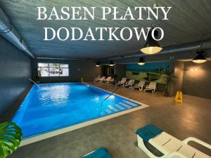 a swimming pool with a sign that reads benson party doodatown at Great Polonia Sand Beach Mielno in Mielno