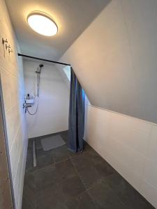 een badkamer met een douche en een douchegordijn bij Rustikale alte Fachwerk Burg in Winden bei Nassau in Winden