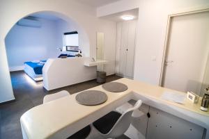 a white room with a bed and a table and chairs at Shape-Meander in Kalymnos +23 photos