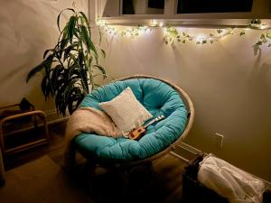 a round chair with a pillow and scissors in a room at Boho-chic Spacious Basement Apartment in Toronto