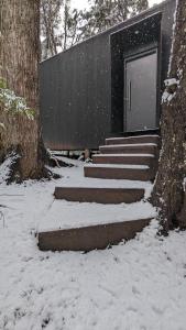 a set of stairs in the snow next to a building at El Bosque in San Carlos de Bariloche