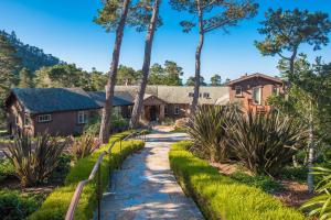 a path leading to a house with palm trees at 3707 Pacific's Edge Sanctuary home in Carmel