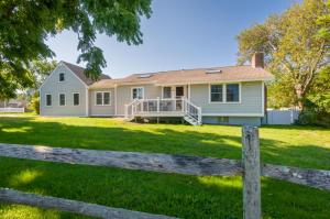 a house with a fence in front of it at 10 Chadwell Avenue Sandwich - Cape Cod in Sandwich