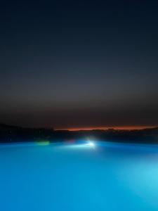 a view of a lake at night at Martins House in Arouca