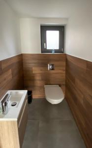 a bathroom with a toilet and a sink at Proche Europa-Park et Rulantica : la Villa HOPLA in Rhinau +3 photos