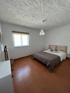 a bedroom with a bed and a window in it at Paradise Villa for 6 at Odemira River&Country in Santa Clara-a-Velha